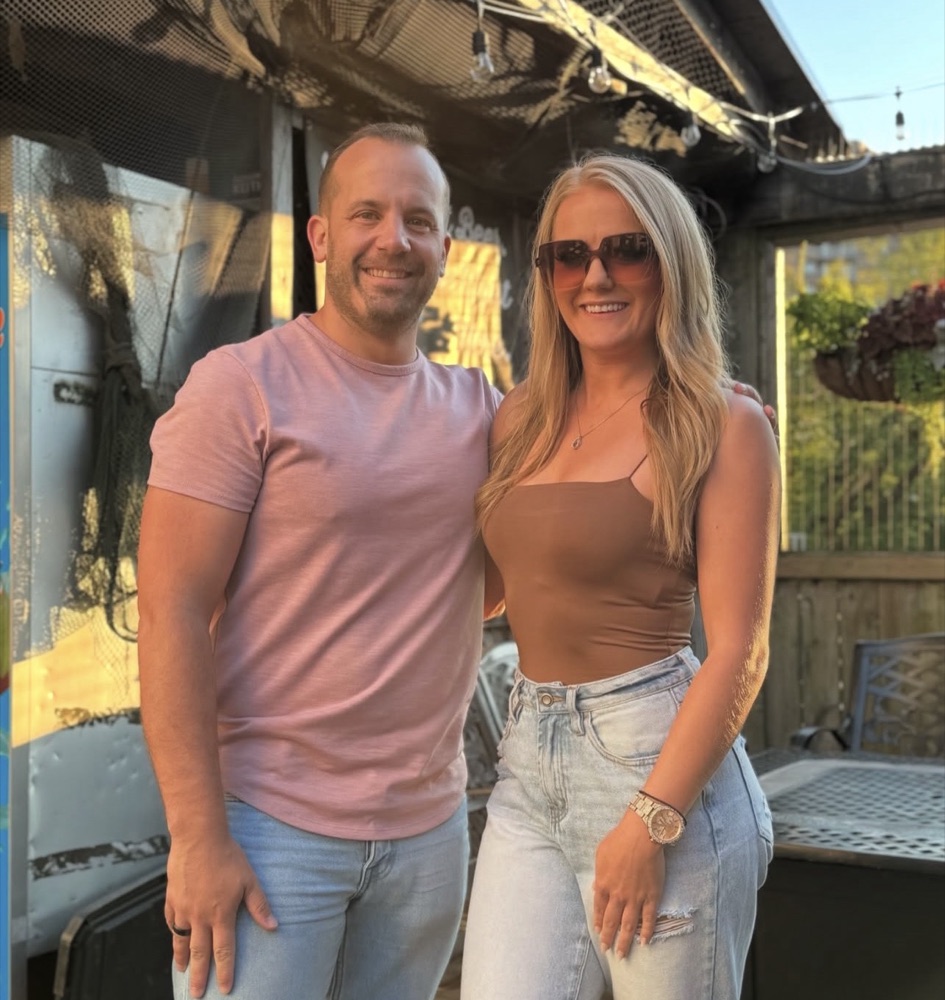 Ashley Frank and Shalisha Pikel smiling together on a sunny patio
